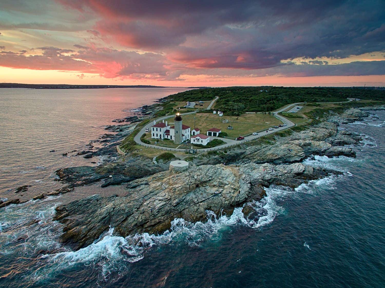 Birds eye view of lighthouse on a partly cloudy afternoon during sunset. Fenway Partners homepage image.